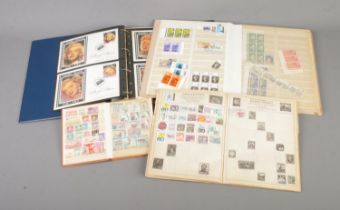 A collection of partially filled world stamp albums to include Marilyn Monroe first day covers,