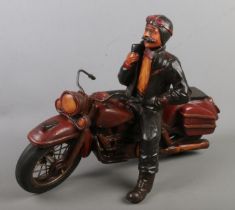 A large composite figure of a man on motorbike.