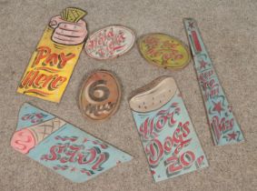 A collection of hand painted fairground signs including Pay Here, Hold Tight and Here We Go signs.