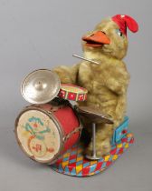 An Alps Japanese tinplate toys formed as a duck playing the drums.