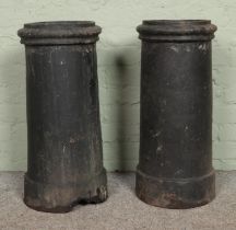 Two painted chimney pots, with false tops, used as planters. 71cm tall. Chip to the base of one