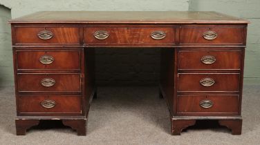 A large mahogany pedestal writing desk with inset tooled leather top and Hepplewhite style oval