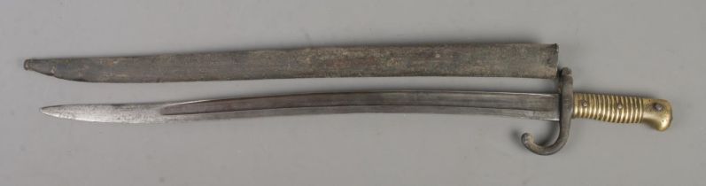 A French M1866 bayonet with scabbard. Blade inscribed to edge and dated 1868. Blade length 57cm.