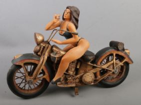 A large composite figure of a girl on motorbike