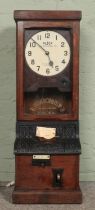 An oak cased Blick Time Recorders Limited Clock, with in/out stamp. Featuring etched logo to glass