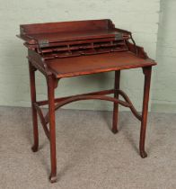 A 20th century mahogany metamorphic table/desk. Height 81cm, Width 74cm, Depth 44cm. General wear