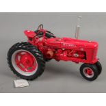 A Franklin Mint 1:12 scale McCormick Farmall Model H tractor.