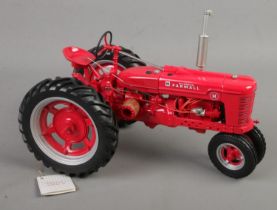 A Franklin Mint 1:12 scale McCormick Farmall Model H tractor.