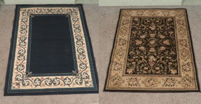 Two rugs; a large blue ground example with floral, cream and Greek key border, with black and