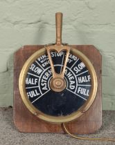 A brass ship's telegraph, mounted on wooden plaque, converted into a lamp. Tested and is working.