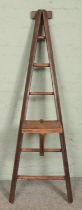 A wooden 'A Frame' six rung ladder, possibly for fruit picking. With additional platform. Height