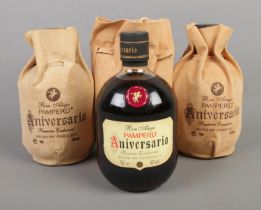 Three bottles of Pampero Aniversario Venezuelan rum, each with storage bags.