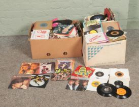 Three boxes of vinyl singles of mainly pop and easy listening to include Elvis Presley, A-ha, Suzi