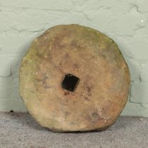 A stone millstone. Diameter 39cm.