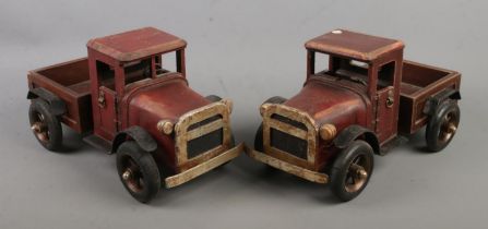 A pair of wooden toy trucks 32cm long