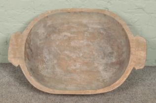 A large wooden dough bowl. 84cm long