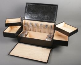 A mid 20th century Elizabeth Arden vanity case with four hinged compartments and fitted glass