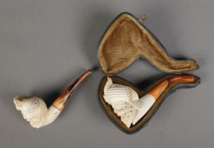 Two carved figural Meerschaum pipes depicting bearded men wearing turbans with simulated tortoise