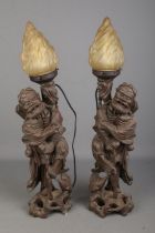 A pair of Chinese wooden carved lamps with flame glass shades In need of rewiring and repair