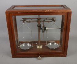 A set of WBN Glasgow scientific chemical scales in mahogany glazed case. Hx37cm