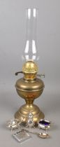 A brass oil lamp along with a collection of white metal items. Includes Mosda Streamline 500