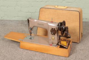 A cased Singer 201K sewing machine.