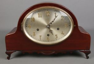 A large carved mahogany Westminster chime mantel clock. Silvered oval dial. (28cm x 42cm)