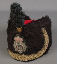 A military busby with stitched cap badge.