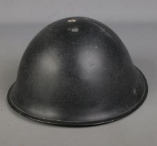 A WWII tin tommy helmet.