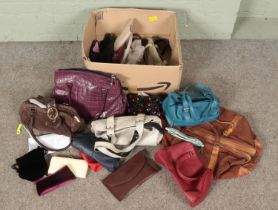 A box of mostly ladies handbags. Includes leather examples, holdall, purses etc.