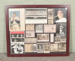 A large framed baseball display with copies of newspaper clippings and pictures relating to Joe