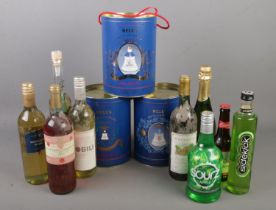 A collection of spirits and wines including bells whisky commemorative royal decanters. All