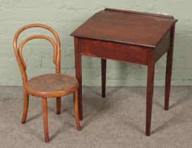 A small stained pine child's desk with bentwood chair