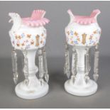 A pair of cream and pink glass lustre vases with cut glass spike drops and hand painted floral