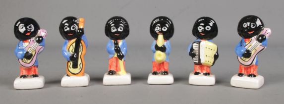 Six Carlton Ware ceramic Golly musicians to include guitarist, singer, saxophonist, cellist and