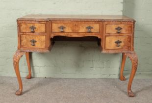 A Queen Anne style carved walnut desk/dressing table. (78cm x 116cm x 55cm)