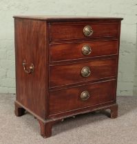 A small mahogany chest of four drawers with twin brass handles. (72cm x 60cm x 47cm)