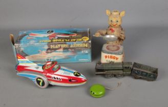 A collection of vintage tin plate toys to include boxed Great Flying Boat, battery operated Piggy