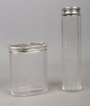 Two silver and tortoiseshell topped glass dressing table jars. Assayed for London, 1912.