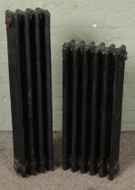 Two cast iron radiators one being four-bar and other being six-bar.