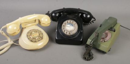 Three vintage/retro telephones, including two rotary dial examples.