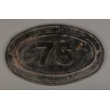 A British Railway cast iron bridge plate, 76A. Widest diameter: 45cm. Has been repainted black.