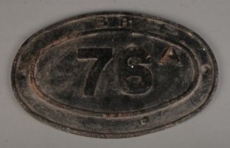 A British Railway cast iron bridge plate, 76A. Widest diameter: 45cm. Has been repainted black.