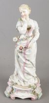 A Meissen figure formed as a maiden holding a hand fan. (35cm)