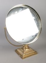 A Durlston Design Ltd. circular mirror raised on square brass stepped Corinthian base.