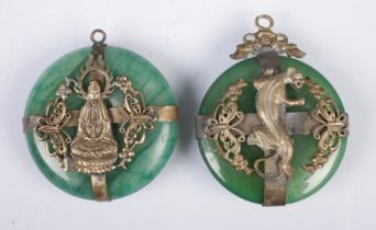 Two similar Tibetan style pendants of white metal and jade colour design depicting a tiger and