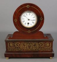 An ornate carved mahogany mantel clock with brass inlay decoration. (34cm x 30cm)