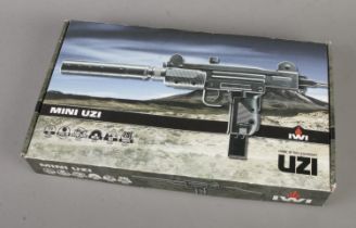 A boxed IWI mini UZI Co2 steel BB gun.