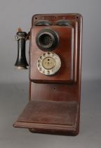 An early 20th century wall mounted stick phone and bell box.