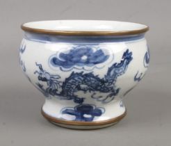 A Chinese blue and white bowl. Decorated in underglaze blue with a dragon, having gilt metal